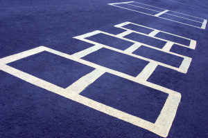 hopscotch game at a school, white board on blue